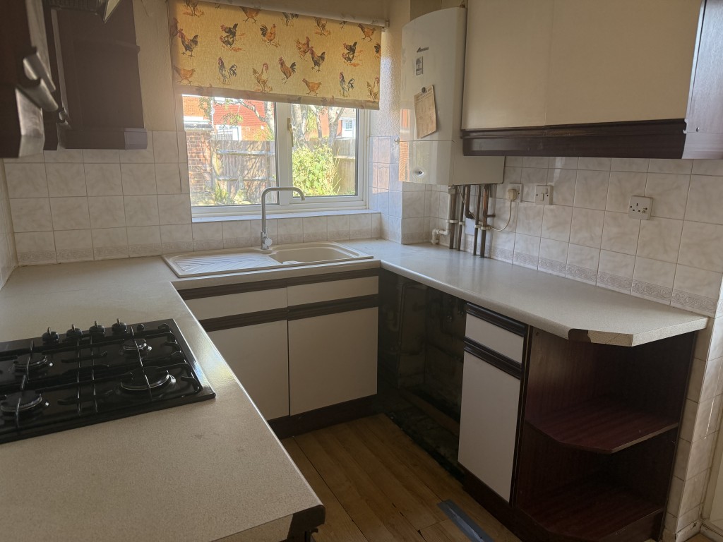 Lot: 146 - THREE-BEDROOM END-TERRACE HOUSE WITH GARAGE - Ground floor kitchen with counter space and combi boiler